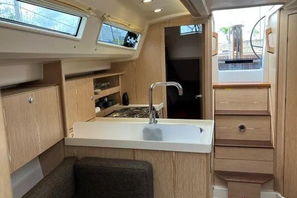 Slide: The Image of Interior of 2017 Hanse 315 sailboat with modern kitchen and wooden finish. - 28