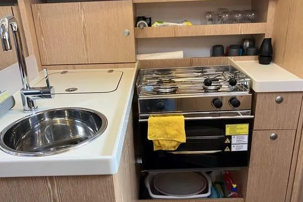 Slide: The Image of Compact kitchen in a 2017 Hanse 315 yacht with sink, stove, and storage. - 29