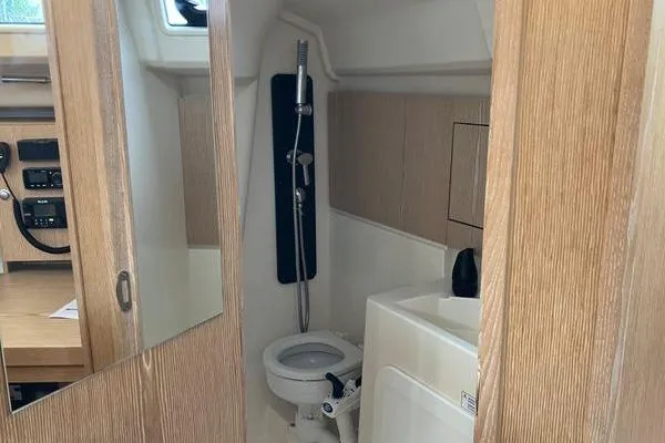 Slide: The Image of Interior of 2017 Hanse 315 yacht bathroom with shower and wooden cabinetry. - 33