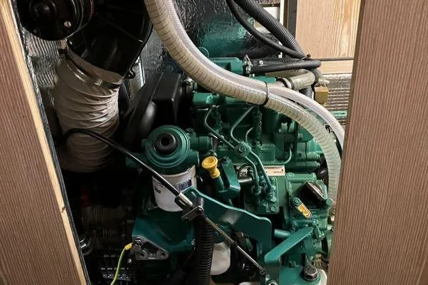 Slide: The Image of Engine compartment of a 2017 Hanse 315 sailboat, showcasing mechanical components and hoses. - 36