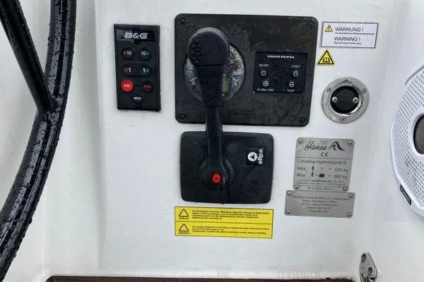 Slide: The Image of Control panel of a 2017 Hanse 315 sailboat with throttle and warning labels. - 6