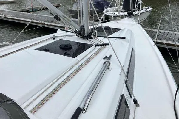 Slide: The Image of 2017 Hanse 315 sailboat deck view at marina, showcasing rigging and sleek design. - 8