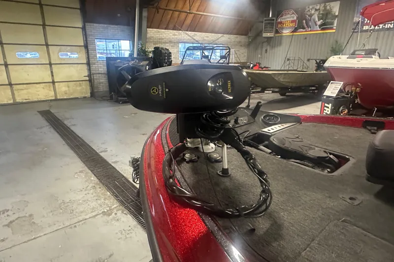 Slide: The Image of 2019 Triton 18 TrX boat with trolling motor in a showroom. - 11