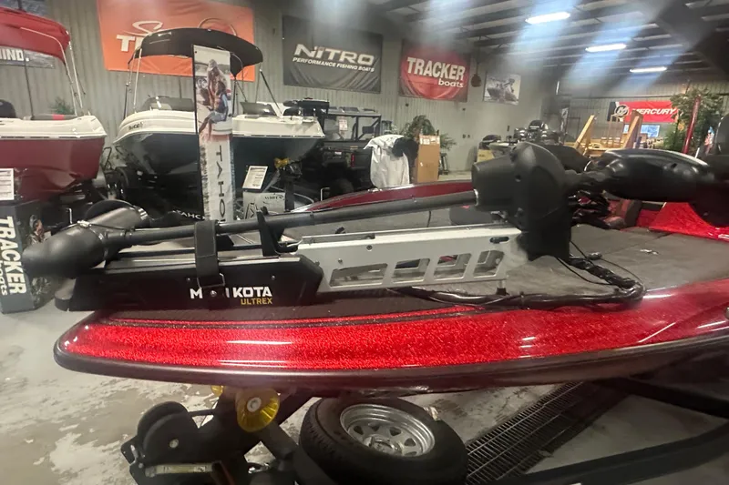 Slide: The Image of 2019 Triton 18 TrX boat with Minn Kota Ultrex motor in showroom. - 12