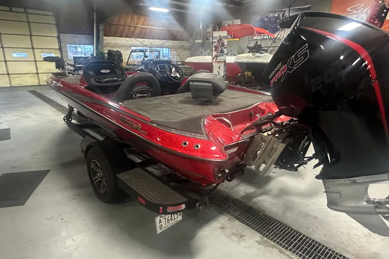 Slide: The Image of 2019 Triton 18 TrX bass boat in a showroom, featuring a powerful Pro XS engine. - 5