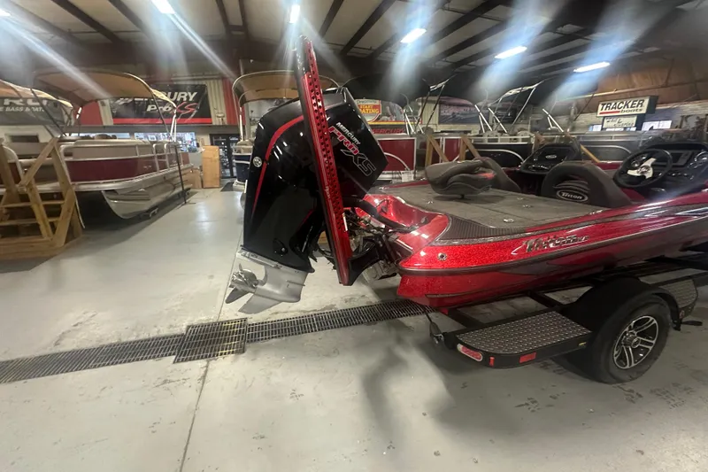 Slide: The Image of 2019 Triton 18 TrX boat with powerful outboard motor in showroom setting. - 6