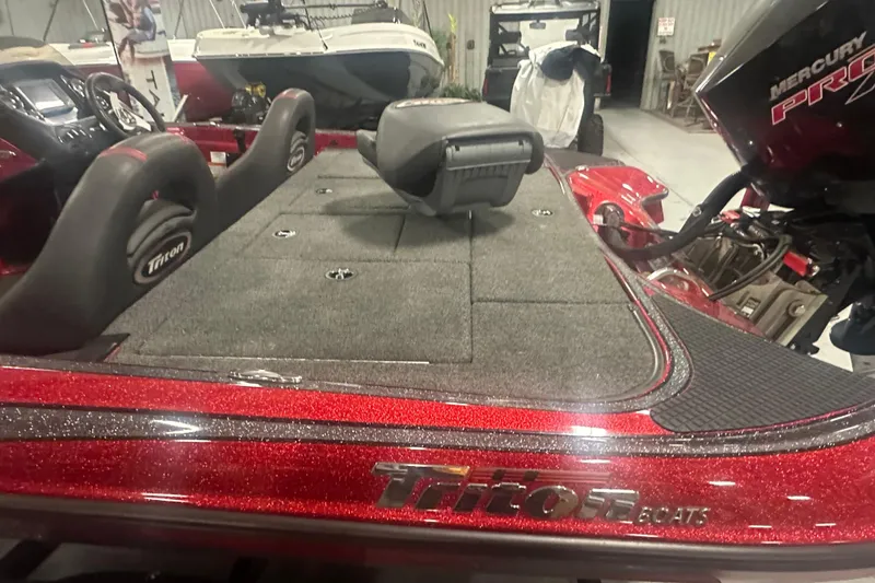Slide: The Image of 2019 Triton 18 TrX boat interior with red glitter finish and Mercury Pro engine. - 7