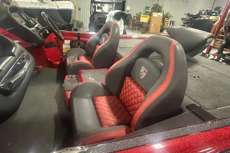 Slide: The Image of 2019 Triton 18 TrX boat interior with red and black seats, steering wheel, and dashboard. - 9