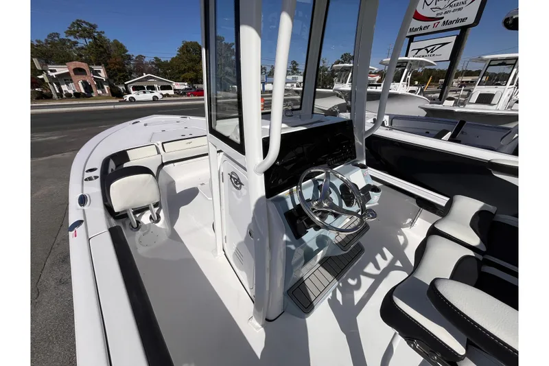 Slide: The Image of 2026 Tidewater 2300 Carolina Bay boat interior with steering console and seating. - 14
