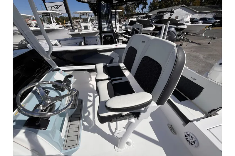 Slide: The Image of 2026 Tidewater 2300 Carolina Bay boat interior with steering wheel and seating. - 15