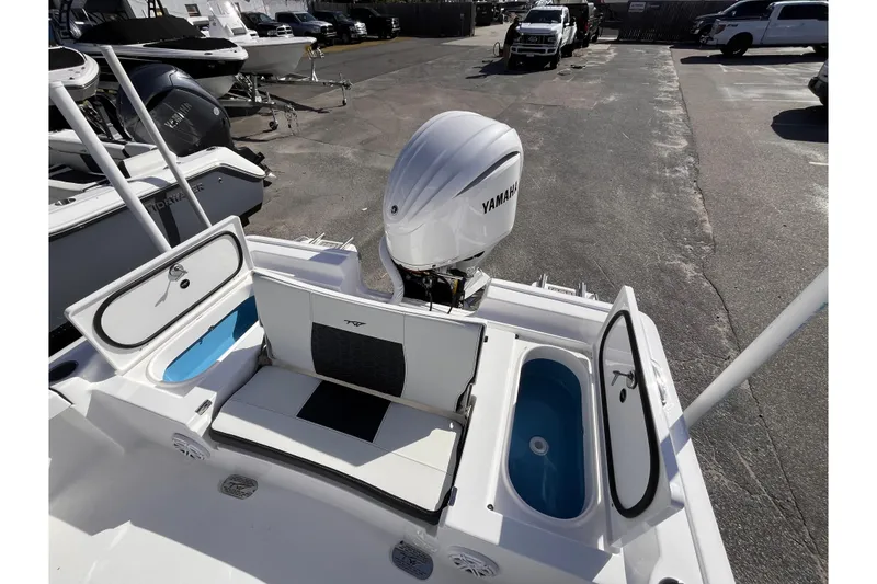 Slide: The Image of 2026 Tidewater 2300 Carolina Bay boat with Yamaha engine, featuring storage compartments and seating. - 16