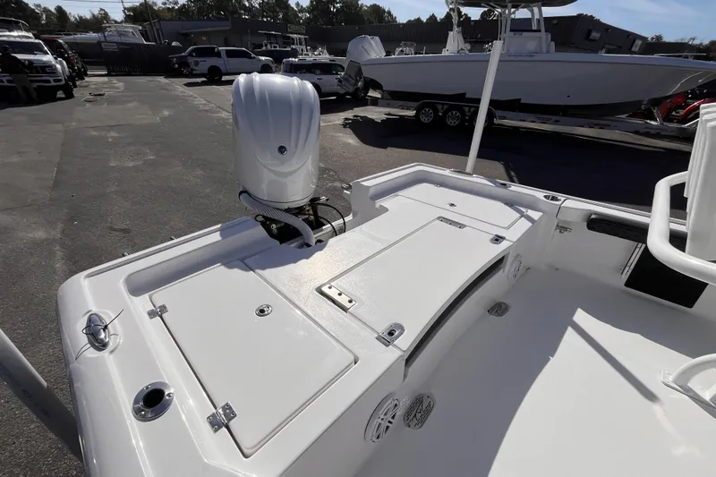 Slide: The Image of 2026 Tidewater 2300 Carolina Bay boat with outboard motor in a parking lot. - 5