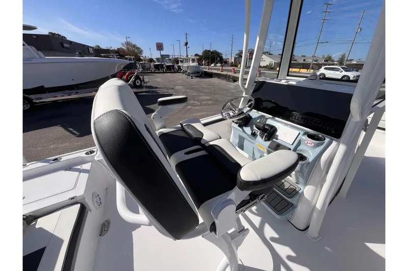 Slide: The Image of 2026 Tidewater 2300 Carolina Bay boat interior with steering console and seating. - 7