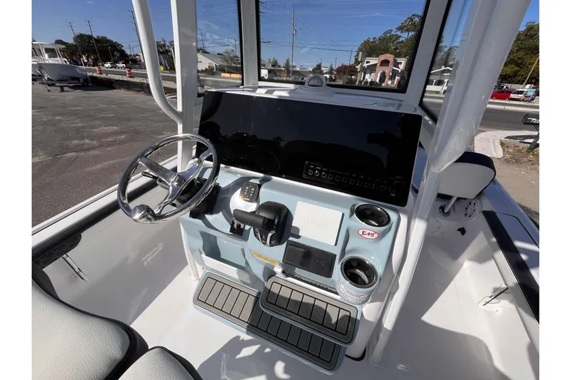 Slide: The Image of 2026 Tidewater 2300 Carolina Bay boat console with steering wheel and controls. - 8