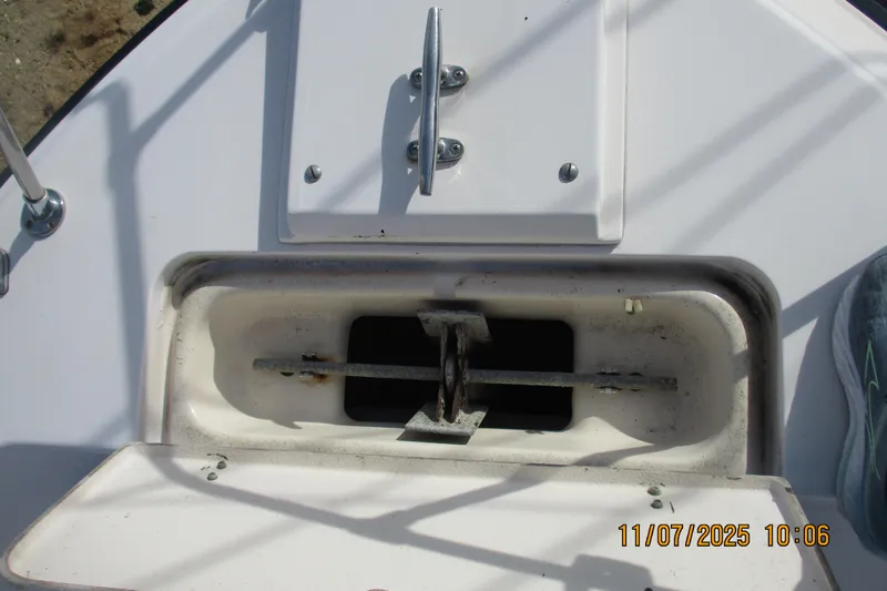 Slide: The Image of Anchor locker of 1996 Grady-White Sailfish 272 boat, open with visible anchor mechanism. - 10