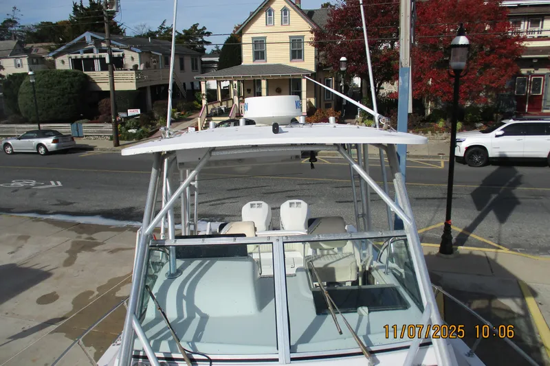 Slide: The Image of 1996 Grady-White Sailfish 272 boat docked near residential street. - 12