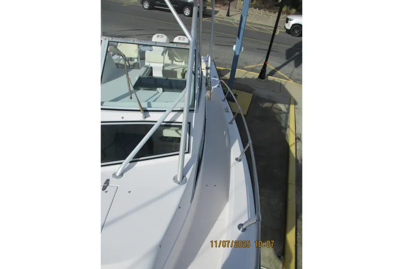 Slide: The Image of 1996 Grady-White Sailfish 272 boat deck view with railing and windshield. - 13
