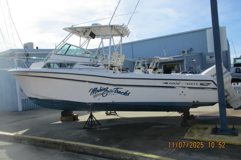 Slide: The Image of 1996 Grady-White Sailfish 272 boat on display at a marina. - 17