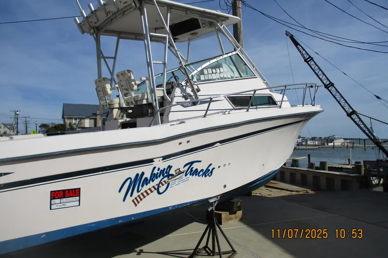 Slide: The Image of 1996 Grady-White Sailfish 272 boat for sale, docked near a marina. - 21