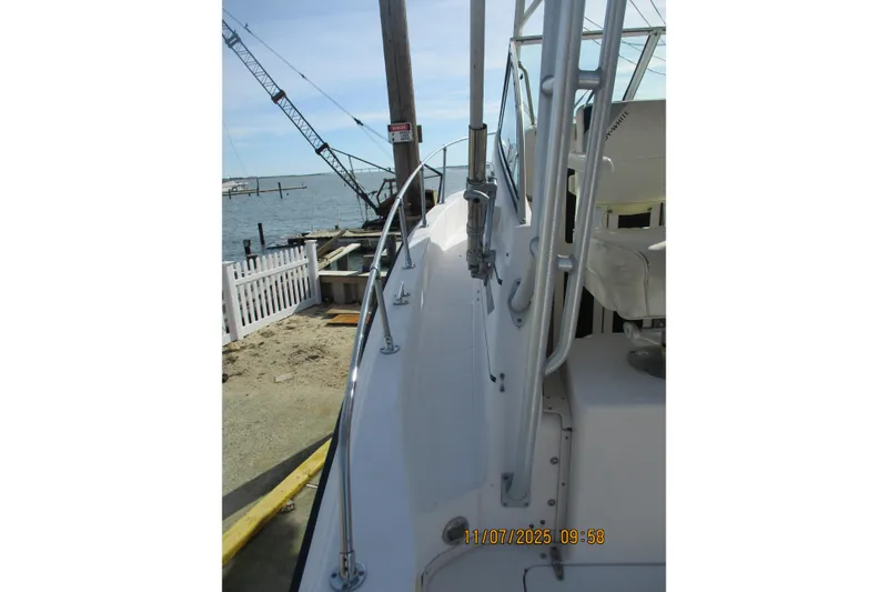 Slide: The Image of 1996 Grady-White Sailfish 272 boat docked by the waterfront. - 27