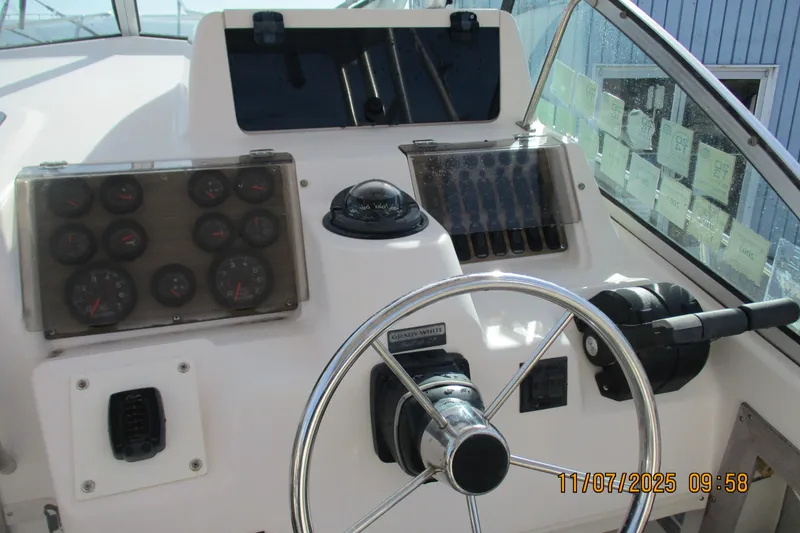 Slide: The Image of 1996 Grady-White Sailfish 272 boat dashboard with steering wheel and instrument panel. - 29