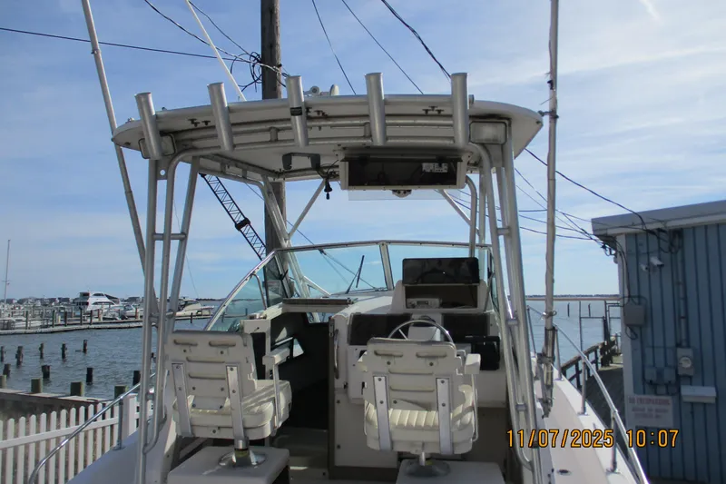 Slide: The Image of 1996 Grady-White Sailfish 272 boat docked at marina, view of helm and seating. - 3