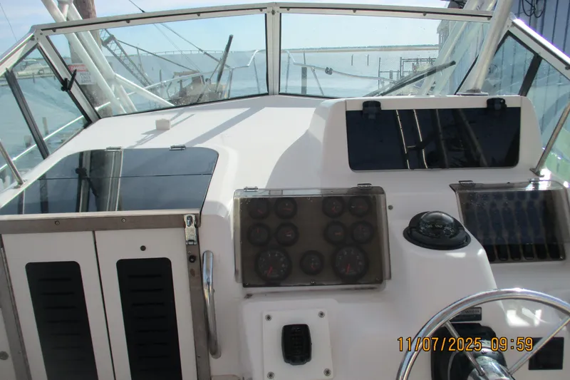 Slide: The Image of 1996 Grady-White Sailfish 272 boat dashboard with gauges and steering wheel. - 30