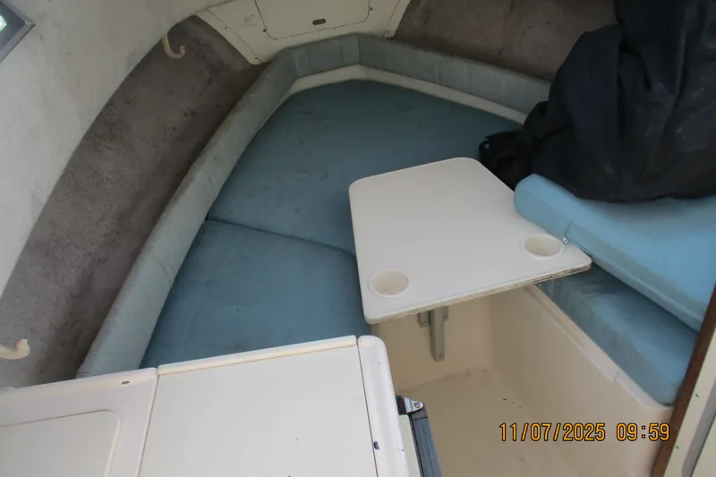 Slide: The Image of Interior cabin of 1996 Grady-White Sailfish 272 with seating and table. - 4