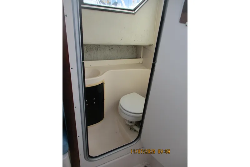 Slide: The Image of 1996 Grady-White Sailfish 272 boat bathroom interior with toilet and window. - 7