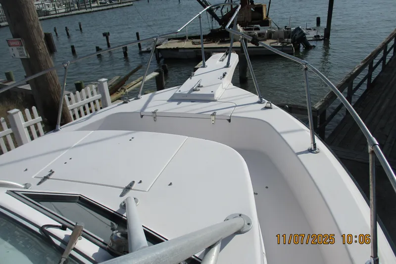 Slide: The Image of 1996 Grady-White Sailfish 272 boat docked at a marina, viewed from the bow. - 9