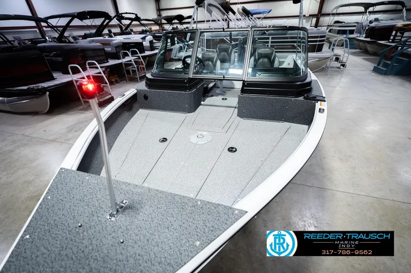 Slide: The Image of 2026 Lund 1700 Explorer Sport boat in showroom, featuring sleek design and modern amenities. - 12