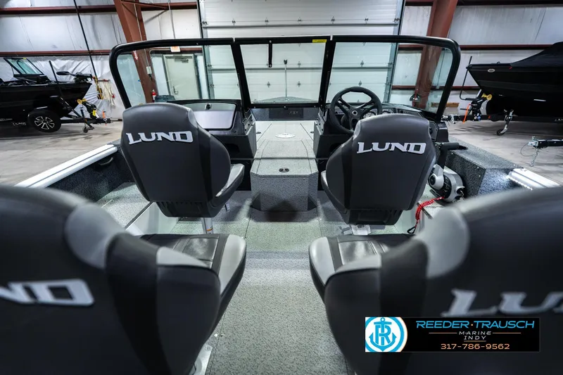 Slide: The Image of 2026 Lund 1700 Explorer Sport boat interior with branded seats in a showroom. - 16