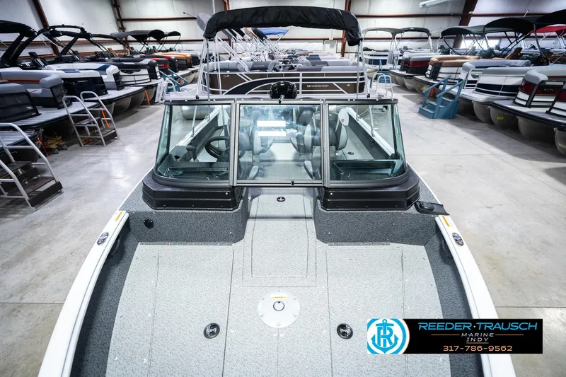 Slide: The Image of 2026 Lund 1700 Explorer Sport boat in showroom, surrounded by other boats. - 19