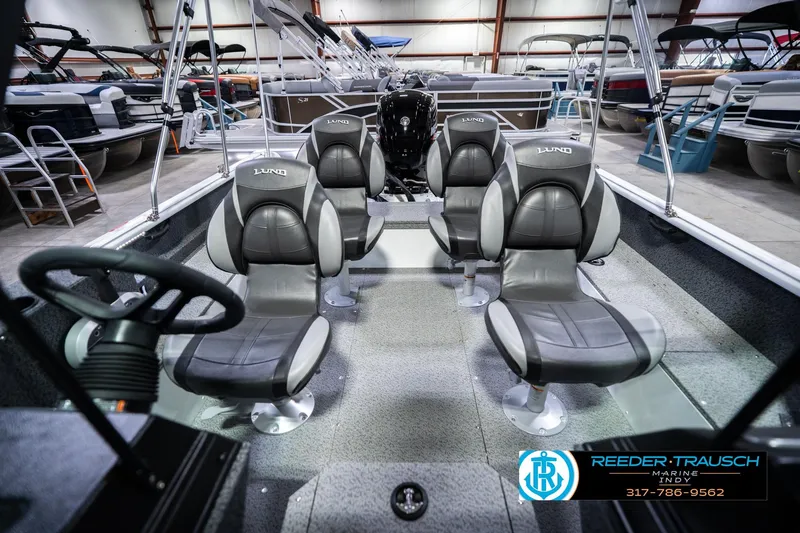 Slide: The Image of 2026 Lund 1700 Explorer Sport boat interior with four seats in a showroom. - 20