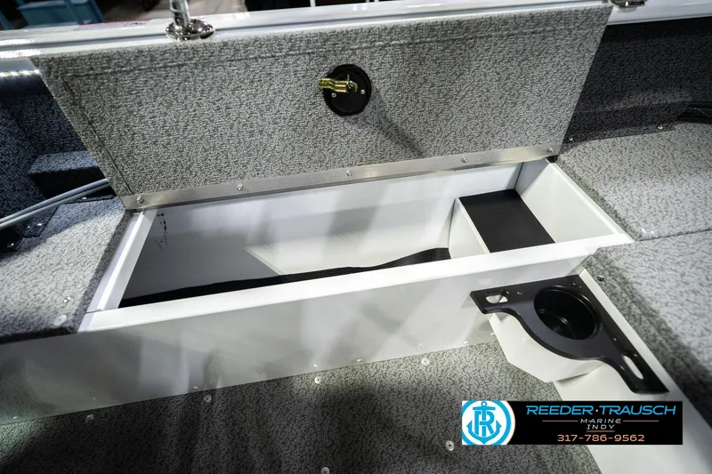 Slide: The Image of 2026 Lund 1700 Explorer Sport boat storage compartment with cup holder, Reeder-Trausch Marine logo. - 27