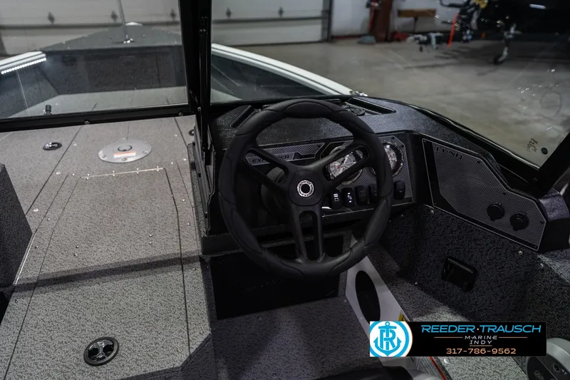 Slide: The Image of 2026 Lund 1700 Explorer Sport boat interior with steering wheel and dashboard controls. - 33