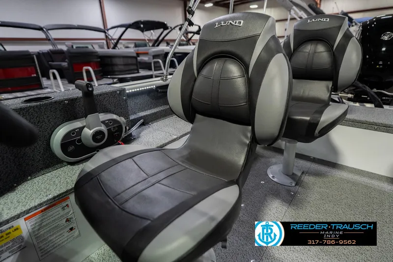 Slide: The Image of 2026 Lund 1700 Explorer Sport boat seats and controls in showroom display. - 37