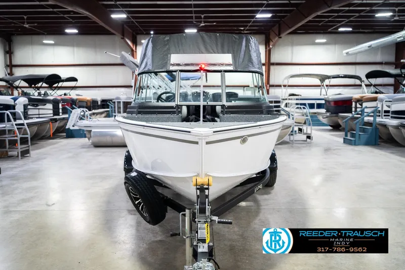 Slide: The Image of 2026 Lund 1700 Explorer Sport boat in showroom, front view, on trailer. - 5