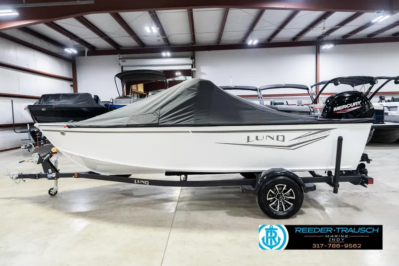 Slide: The Image of 2026 Lund 1700 Explorer Sport boat in showroom, covered and on trailer. - 60