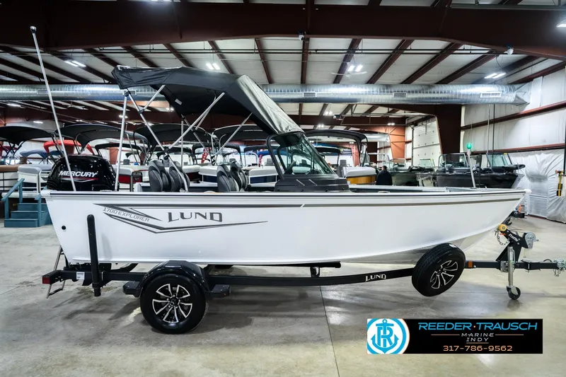 Slide: The Image of 2026 Lund 1700 Explorer Sport boat in showroom, side view with trailer. - 7