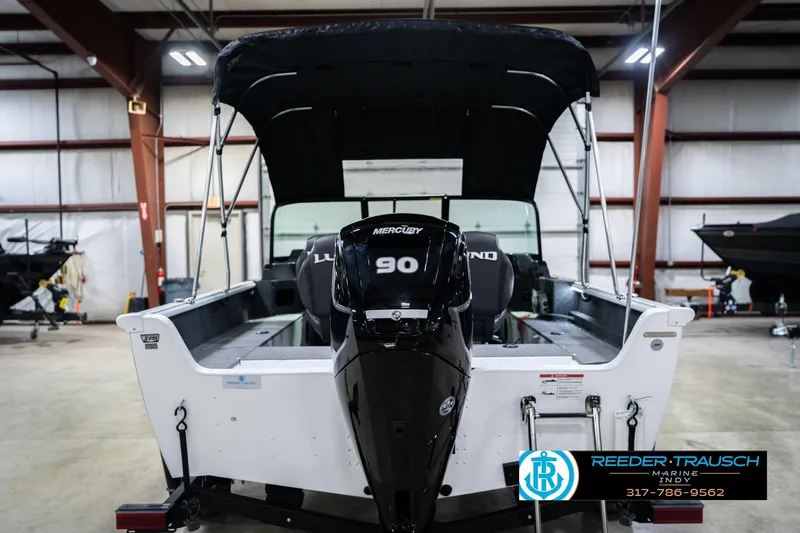 Slide: The Image of 2026 Lund 1700 Explorer Sport boat with Mercury 90 engine in showroom. - 9