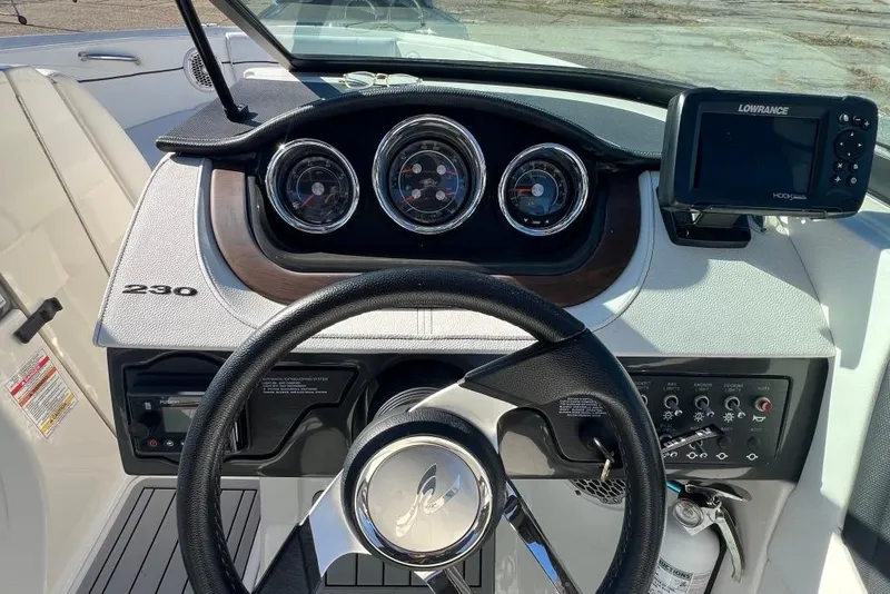 Slide: The Image of Dashboard of a 2016 Sea Ray 230 SLX boat with gauges and navigation system. - 18