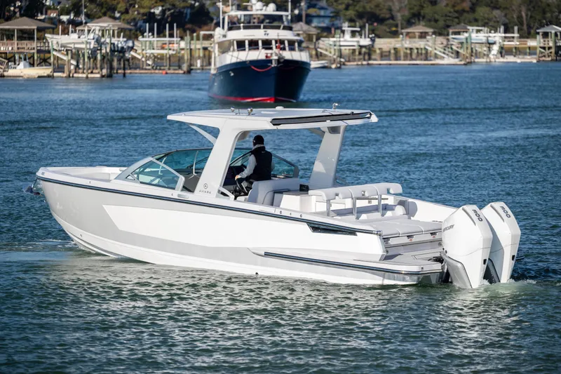 Slide: The Image of 2023 Aviara AV32 OB boat cruising on a scenic waterway. - 10