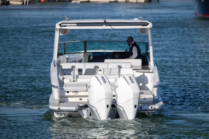 Slide: The Image of 2023 Aviara AV32 OB boat with dual outboard engines on water. - 11