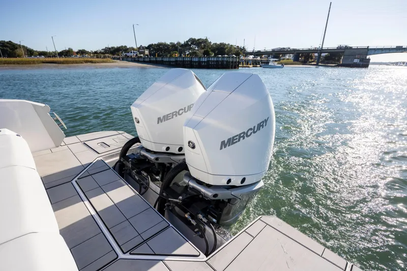 Slide: The Image of 2023 Aviara AV32 OB boat with dual Mercury outboard engines on a sunny waterway. - 13