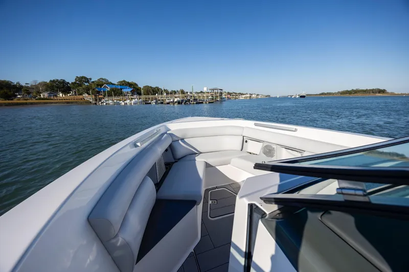 Slide: The Image of 2023 Aviara AV32 OB boat interior with waterfront view, showcasing luxury seating and sleek design. - 26