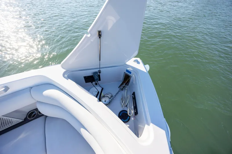 Slide: The Image of 2023 Aviara AV32 OB boat storage compartment open on calm water. - 27