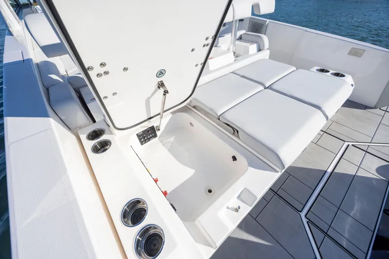 Slide: The Image of 2023 Aviara AV32 OB boat interior with white seating and storage compartment. - 32