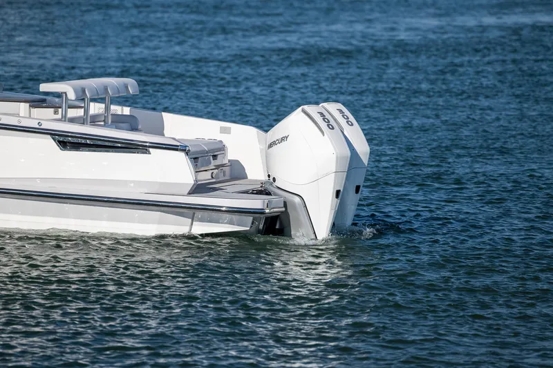 Slide: The Image of 2023 Aviara AV32 OB boat with dual Mercury outboard engines on water. - 9