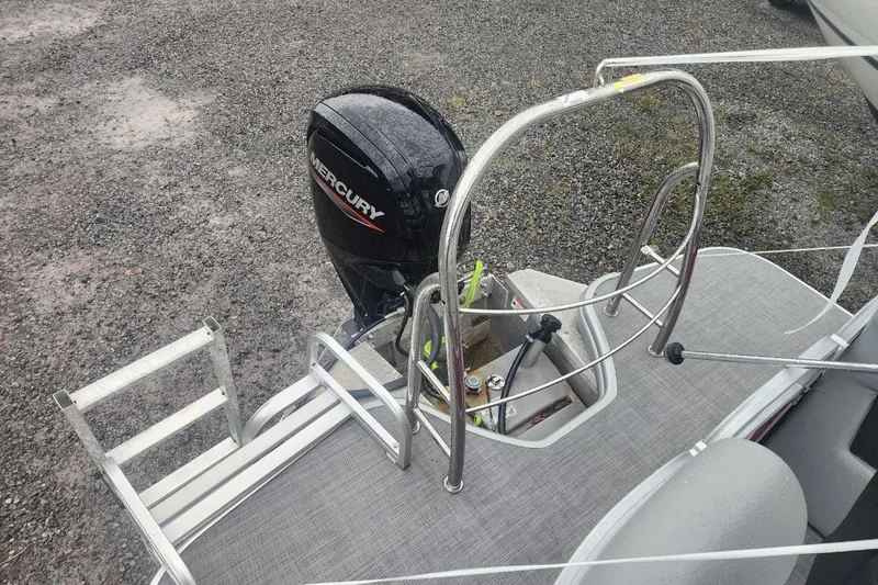 Slide: The Image of Manufacturer Provided Image: 2021 Lowe SS230 Walk-Thru pontoon boat on trailer, featuring spacious seating and sleek design. - 16